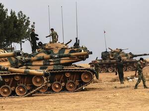 Turkish Army soldiers walking by tanks near Turkish Syrian border of Karkamis. (AFP/File) 