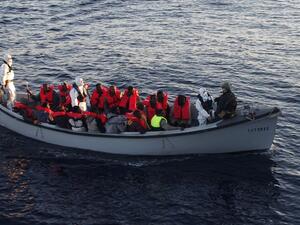 Italian navy personnel and rescued migrants ride in a boat after a resuce operation off the Libyan coast, in the Mediterranean Sea. (AFP/file)  