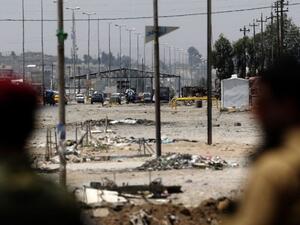 Kurdish Peshmerga forces look at a checkpoint held by Daesh militants on June 16, 2014 in Iraq's second city of Mosul. (AFP Photo/Karim Sahib)