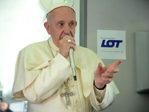 Pope Francis speaks to journalists during a press conference on the plane after his visit to Krakow for the World Youth Days, on July 31, 2016. (AFP/Filippo Monteforte)