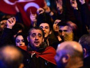 People gesture and wave flags as Turkish residents of the Netherlands gather for a protest outside Turkey's consulate in Rotterdam on March 11, 2017. (AFP/File) 