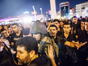 A Turkish solder is detained by police at Taksim square as people protest agaist the military. (AFP/File) 