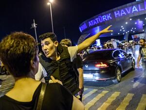A Turkish police officer directs a passenger at Ataturk airport in Istanbul June 28, 2016 after two explosions followed by gunfire hit Turkey's biggest airport. (AFP/Ozan Kose) 