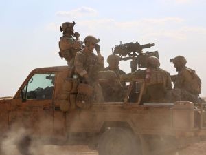 Armed men in uniform identified by Syrian Democratic Forces as US special operations personnel ride in a pickup truck in the village of Fatisah in the northern Syrian province of Raqa on May 25, 2016. (AFP/Delil Souleiman)