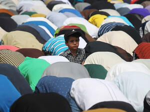 An Iraqi boy looks on as supporters of Shiite cleric Moqtada al-Sadr attend Friday prayers in Baghdad's Sadr City. (AFP/File)
