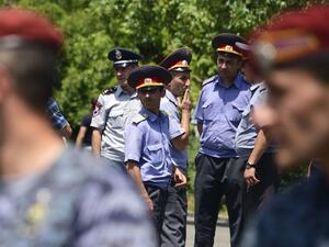 Armenian police officers stand guard as they block the streets to Erebuni police station in Yerevan on July 17, 2016. An armed group with links to an imprisoned opposition leader on July 17, 2016 seized a police building in Yerevan and took hostages, the national security service said. (AFP/Karen Minasyan)