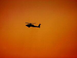 A military helicopter flies over the desert at Al-Hamra military camp, west of the Gulf emirate of Abu Dhabi. (AFP/File)