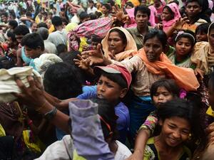 Newly arrived Rohingya refugees scuffle for relief supplies at Kutupalong refugee camp in the Bangladeshi locality of Ukhia on September 9, 2017 (Munir Uz Zaman/AFP)