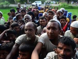 Rohingya people wait for relief supplies near a refugee camp in Kutupalong in the Bangladeshi district of Ukhia on September 8, 2017 (Munir Uz Zaman/AFP)