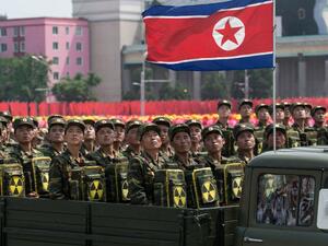 In this photo taken on July 27, 2013, Korean People's Army (KPA) soldiers carrying packs marked with a radioactive symbol take part in a military parade in Pyongyang (Ed Jones/AFP)
