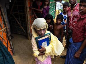 Saleema Khanam, 8, leaves her tent as she goes to a madrassa (Islamic seminary) for her studies in Kutupalong camp, in Ukhia near Cox's Bazar. (AFP)