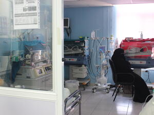 Ayesha (not her real name), a new mother from Syria, waits by one of her twins in Neo-Natal care unit in the MSF Mother And Child Hospital in Irbid, Jordan.