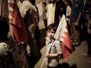 صبي بحريني يحمل العلم الوطني خلال تظاهرة مناوئة للحكومة/أ.ف.ب