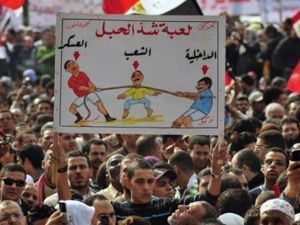 رجل يرفع لافتة خلال الاحتجاج ضد المجلس العسكري بميدان التحرير بالقاهرة يوم الجمعة