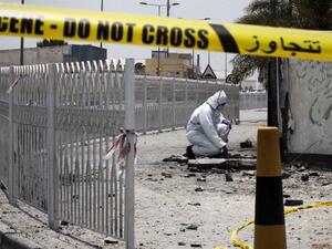 A Bahraini forensic police officer inspects the site of a bomb blast in the village of Sitra in 2015. (AFP/File) 
