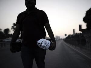 An anti-regime protester walks the streets in Bahrain. (AFP/File)