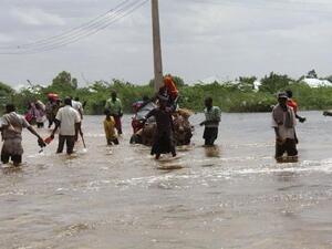 Residents in Beledweyne, Somalia, walk through the flood waters. (Twitter)