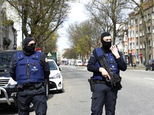 Belgian police stand guard near a warehouse connected to the militants in Etterbeek, Belgium. (AFP/Thierry Charlier)