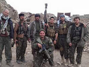 Scurfield is pictured kneeling in front of a group of fellow foreign fighters working alongside the Kurds against Daesh in Syria. (AFP/File) 
