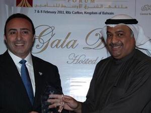 Abdul Rahman Mohammed Al Baker, Executive Director of Financial Institutions Supervision at the Central Bank of Bahrain, presenting the award to Walid Sidani, CEO of ADNIC
