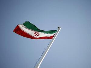 An Iranian flag flutters outside an annual oil and gas conference in Tehran. (Reuters)