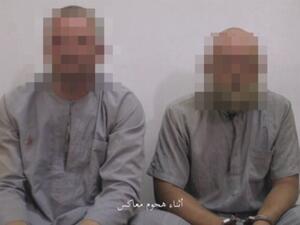 Speaking Russian and wearing matching grey outfits, the two men appear to have been beaten or injured with one showing a cut eye and bruises, in an Amaq video.