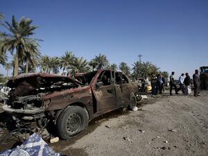 People examine the debris after a truck bomb exploded at a checkpoint in Hilla. (AFP/Haidar Hamdani)