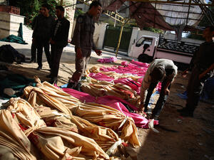 People identify the bodies of loved ones following a reported airstrike by Syrian government forces on the rebel-held town of Douma (AFP/File Photo)	