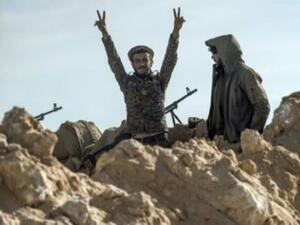 مقاتلان من قوات سوريا الديموقراطية خلال عملية لدحر تنظيم الدولة الإسلامية من آخر جيب له في شرق سوريا

