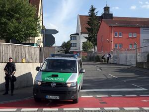 A pliceman stands near a migrant reception center on July 27, 2016 in Zirndorf, southern Germany, following an explosion of a suitcase. (AFP/Daniel Karmann)