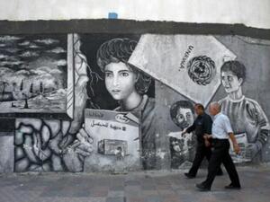 رجلان فلسطينيان أمام المركز الرئيسي لوكالة الاونروا في قطاع غزة
