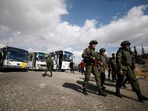 جنود روس وسوريون على مشارف الغوطة الشرقية في دمشق يوم الأربعاء

