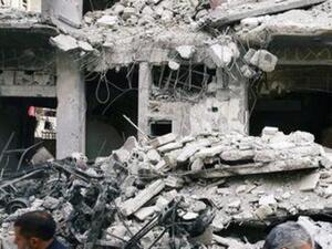 رجلان يسيران وسط مبان دمرت في بلدة دوما المحاصرة في الغوطة الشرقية 
