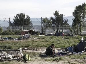 A refugee sits on the ground near destroyed tents during a police operation to clear a makeshift camp for refugees and migrants at the border between Greece and Macedonia near the village of Idomeni, northern Greece on May 25, 2016. (AFP/Yannis Kolesidis)