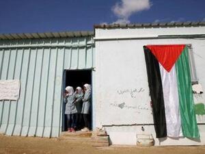 فتيات فلسطينيات ينظرن من بيوت متنقلة تستخدم كمدارس في الضفة الغربية
