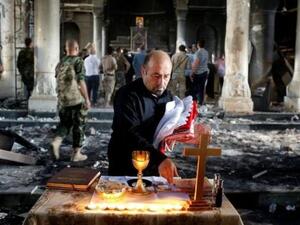 مسيحي عراقي يعد لإقامة قداس في كنيسة الطاهرة الكبرى في بلدة قرة قوش قرب الموصل
