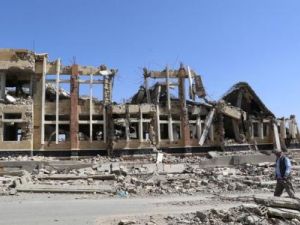 رجل يمر بجانب مبنى دمرته ضربات جوية لقوات التحالف التي تقودها السعودية في شمال غرب مدينة صعدة باليمن 
