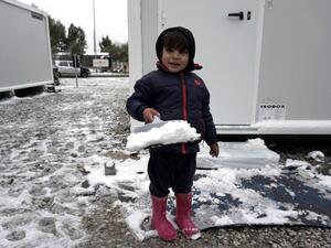 A child plays in the snow at the Kara Tepe camp on the island of Lesbos following heavy snowfalls on January 7, 2017. (AFP/Stringer)