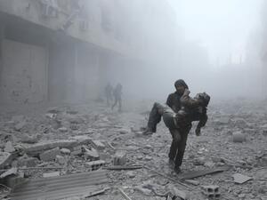 A wounded man is carried following an air strike on the rebel-held town of Erbin in Eastern Ghouta near Damascus on January 2, 2018 ABDULMONAM EASSA/AFP/FILE