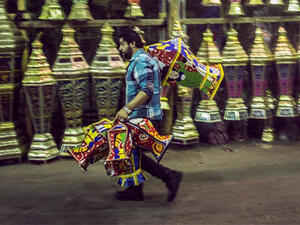 An Egyptian man carries traditional lanterns, known in Arabic as "Fanous", sold in Cairo during the Muslim holy month of Ramadan. (AFP/File)