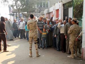 Men line up to vote at a polling station in Cairo on November 22, 2015. (AFP/STR)