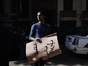 ناشط من حركة 6 ابريل يحمل يافطات تدعو الى التصويت بلا على مشروع الدستور/أ.ف.ب