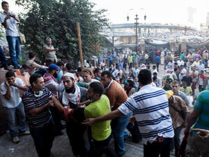 An injured supporter of deposed Egyptian President Mohammed Morsi is carried into the Fateh Mosque at Ramses Square (Image credit: Getty)