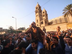 Egyptians gather outside the Saint Peter and Saint Paul Coptic Orthodox Church in Cairo on December 11, 2016. (AFP/Mohamed Meteab)
