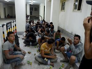Survivors from a boat that capsized, off Egypt's north coast, sit in a police station in Rashid in northern Egypt, on September 21, 2016. (AFP/Mohammed El-Shahed)