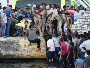 Egyptians stand on the shore as they wait for the recovery of bodies, during a search operation after a boat carrying migrants capsized in the Mediterranean, along the shore in the Egyptian port city of Rosetta on September 22, 2016. (Mohamed El-Shahed)