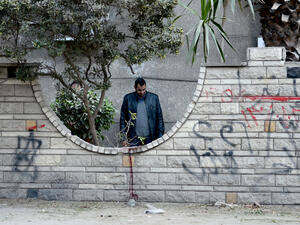 An Egyptian policeman inspects the site of a bomb blast in Cairo on 24 March 2017. (AFP/Mohamed al-Shahed)