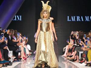 A model walks down the catwalk wearing a Laura Mancini design during the Arab Fashion Week in Dubai. (AFP)