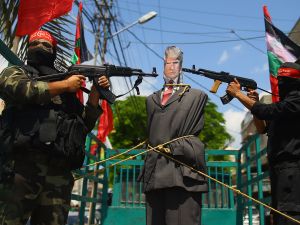 Dozens of supporters crowded at Shuhada Square in the center of the city and torched US flags, as well as photos and an effigy of Donald Trump. (AFP)