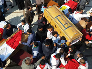 Egyptian clergymen and officials carry the coffins of the victims of a church bombing in Cairo, on December 12, 2016. (AFP/Khaled Desouki)